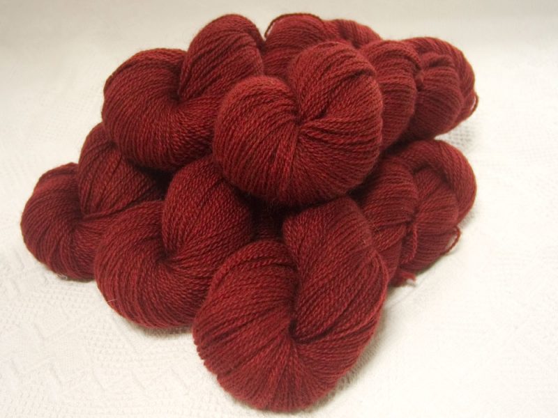 Deep red Bluefaced Leicester (BFL) / Gotland 4-ply (fingering) yarn. Hand-dyed by Triskelion Yarn