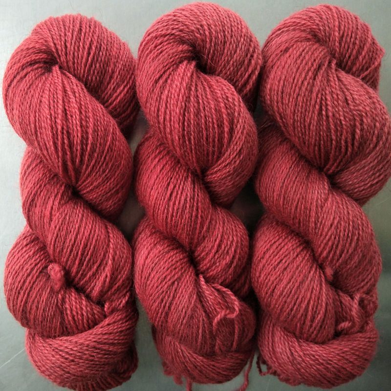 Semi-solid mid red, with brick and scarlet tones Bluefaced Leicester (BFL) / Gotland 4-ply (fingering) yarn. Hand-dyed by Triskelion Yarn