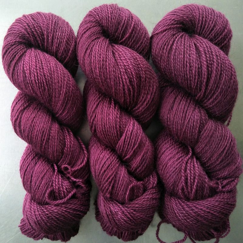 Damson - Mid-tone violet red Bluefaced Leicester (BFL) / Gotland 4-ply (fingering) yarn. Hand-dyed by Triskelion Yarn