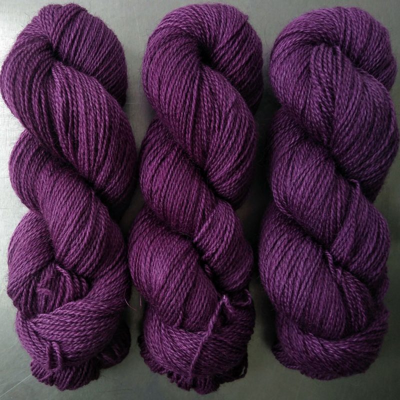 Semi-solid dark purple, with red-violet and royal purple tones Bluefaced Leicester (BFL) / Gotland 4-ply (fingering) yarn. Hand-dyed by Triskelion Yarn
