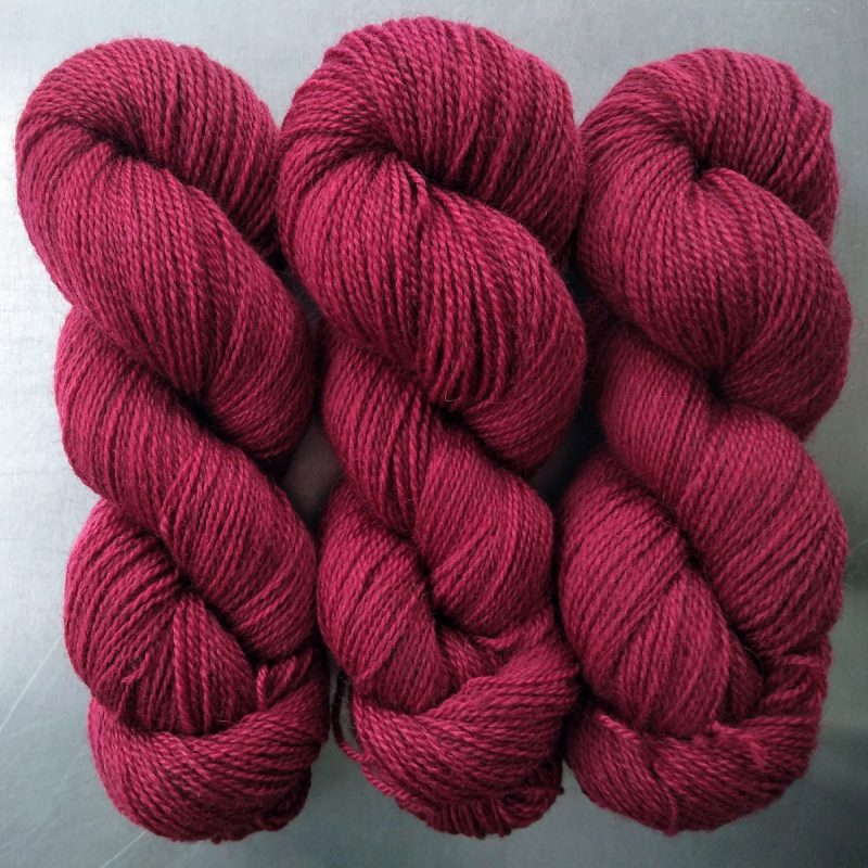 Deep red Bluefaced Leicester (BFL) / Gotland 4-ply (fingering) yarn. Hand-dyed by Triskelion Yarn