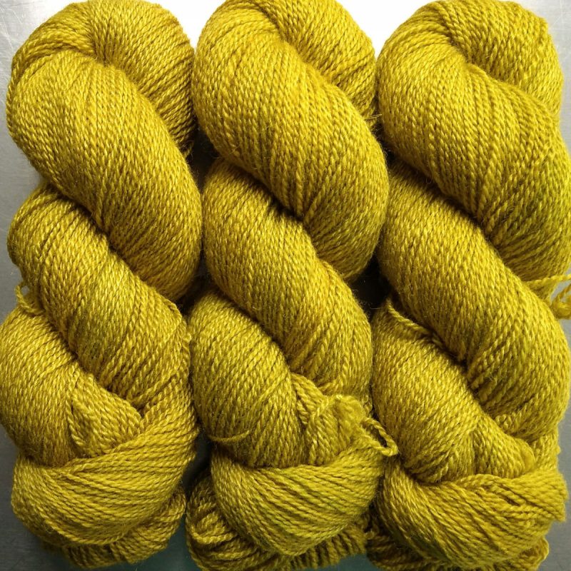 Quince - light greenish yellow Bluefaced Leicester / silk 4-ply yarn. Hand-dyed by Triskelion Yarn.
