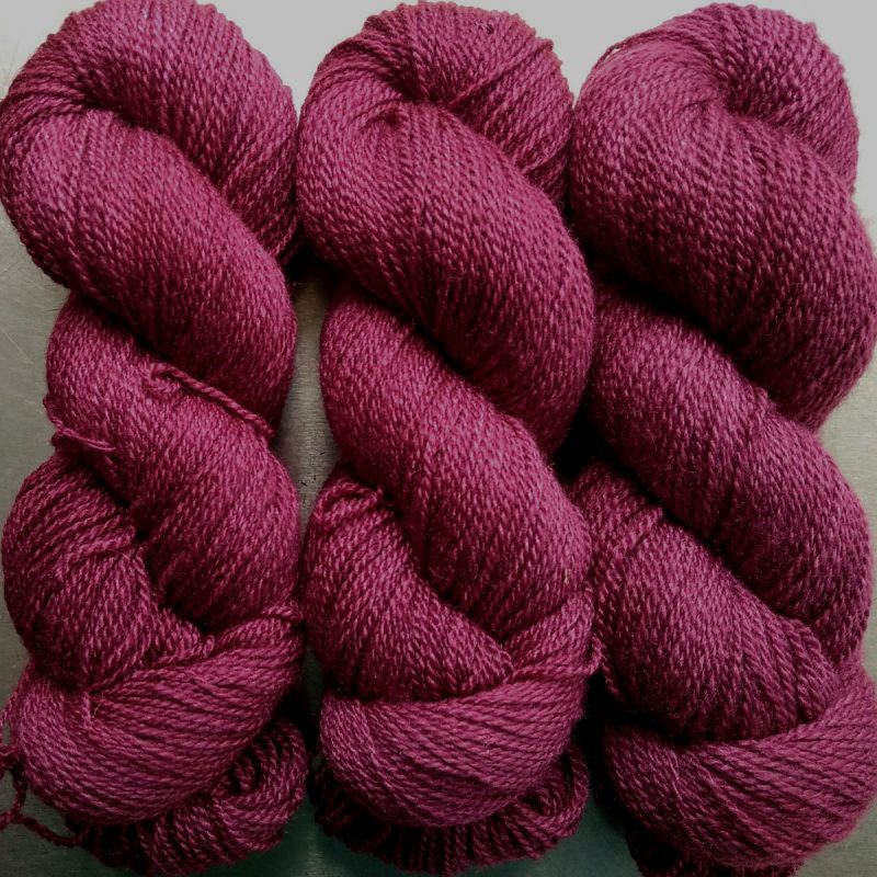 Red Pear - dark purplish red Bluefaced Leicester / silk 4-ply yarn. Hand-dyed by Triskelion Yarn.