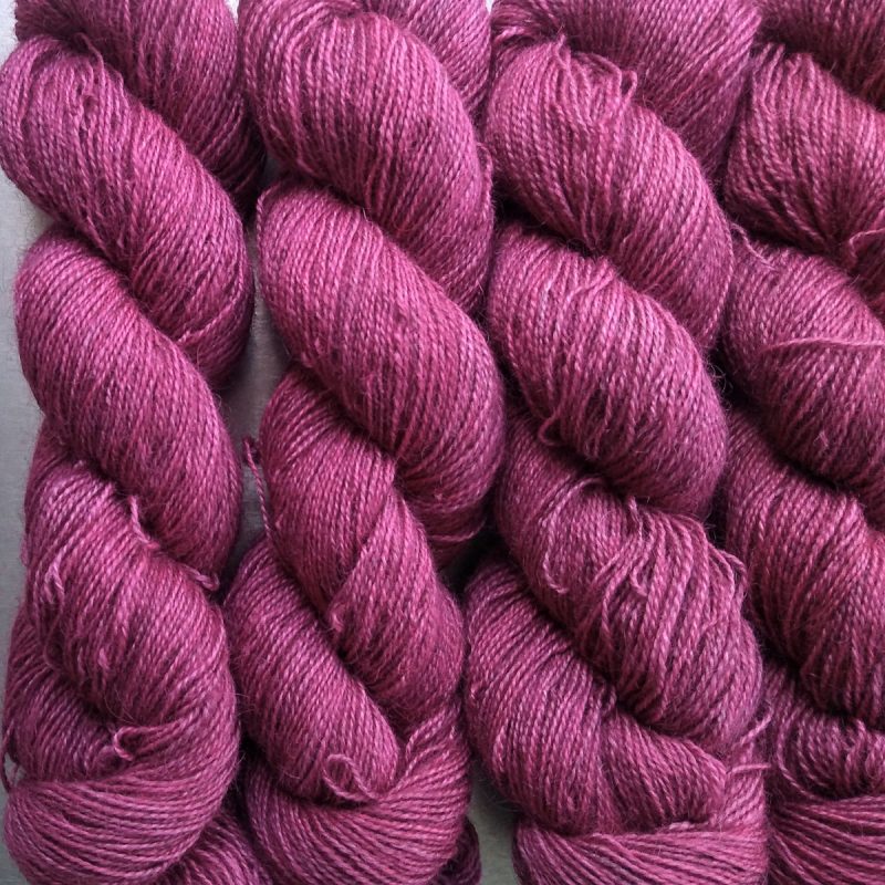 Cassiopeia - Light to mid-tone rose Bluefaced Leicester (BFL) / Gotland / Wensleydale 4-ply (fingering) weight high-twist sock yarn. Hand-dyed by Triskelion Yarn