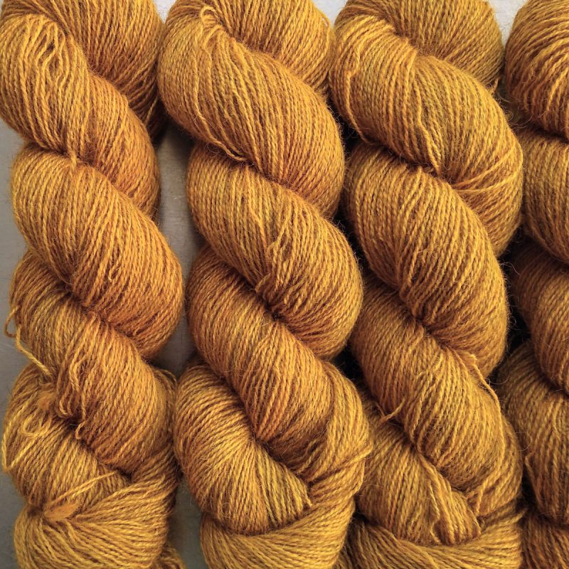 Heaven's Gem - Rich imperial yellow Bluefaced Leicester (BFL) / Gotland / Wensleydale 4-ply (fingering) weight high-twist sock yarn. Hand-dyed by Triskelion Yarn