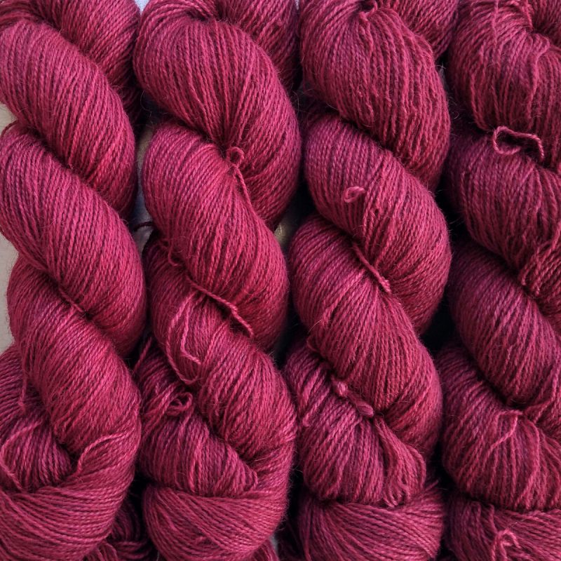 Idisi - Soft mid- to dark tone raspberry Bluefaced Leicester (BFL) / Gotland / Wensleydale 4-ply (fingering) weight high-twist sock yarn. Hand-dyed by Triskelion Yarn