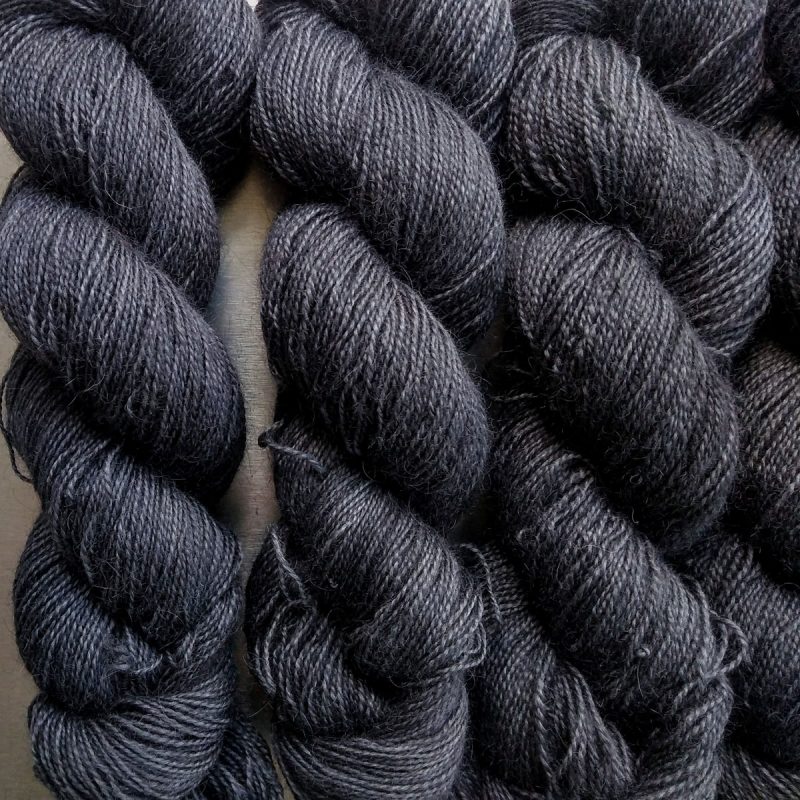 Night - Soft black Bluefaced Leicester (BFL) / Gotland / Wensleydale 4-ply (fingering) weight high-twist sock yarn. Hand-dyed by Triskelion Yarn