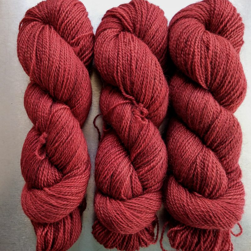 Dark Poppy - Deep scarlet red Bluefaced Leicester (BFL) / Gotland 4-ply (fingering) yarn. Hand-dyed by Triskelion Yarn