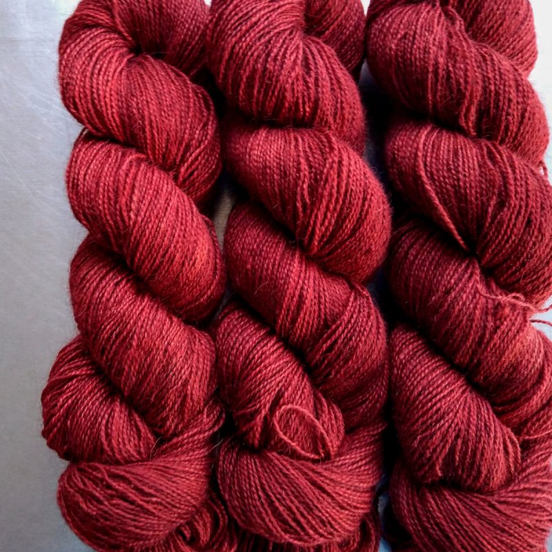 Dark Poppy - Deep scarlet red Bluefaced Leicester (BFL) / Gotland / Wensleydale 4-ply (fingering) weight high-twist sock yarn. Hand-dyed by Triskelion Yarn