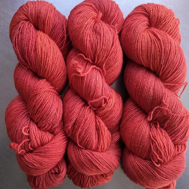 Coral - Strong pinkish orange Falklands Merino and silk blend yarn. Hand-dyed by Triskelion Yarn.