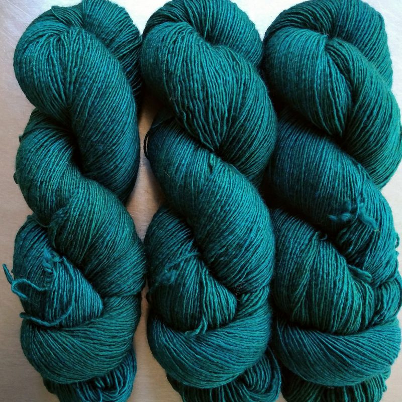 Estuary - Deep green with ultramarine tone Falklands Merino and silk blend yarn. Hand-dyed by Triskelion Yarn.