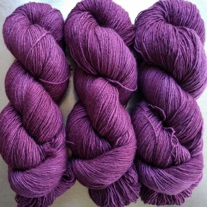 Tyrian Purple - Reddish purple Falklands Merino and silk blend yarn. Hand-dyed by Triskelion Yarn.
