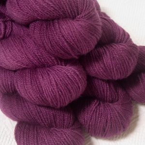 Tyrian Purple - Dark reddish purple Bluefaced Leicester DK (double knit) yarn hand-dyed by Triskelion Yarns