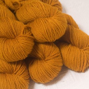 Amber - Dark ochre yellow Bluefaced Leicester worsted weight yarn hand-dyed by Triskelion Yarns