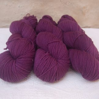Freo - Semi-solid deep red-violet 4-ply/fingering Peruvian Highland wool sock yarn. Hand-dyed by Triskelion Yarn.