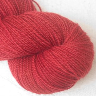 Boötes - Mid- to dark red Corriedale 4-ply/fingering weight yarn. Hand-dyed by Triskelion Studio.