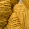 Sandy golden yellow Corriedale thick and thin slub yarn. Hand-dyed by Triskelion Yarn.
