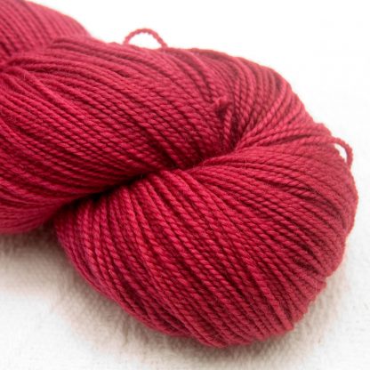 Carnation - Deep rose red GOTS standard organic machine-washable Merino 4-ply / fingering weight yarn. Hand-dyed by Triskelion Yarn