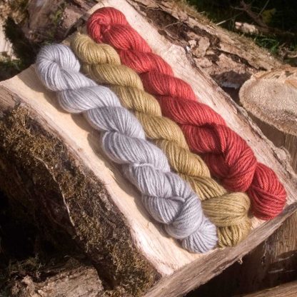 Three Kings, red, yellow and grey baby alpaca double knit (DK) yarn. Hand-dyed by Triskelion Yarn